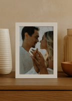 personalized wooden puzzle showing a couple outdoors sharing a romantic moment while displaying their engagement ring framed in white