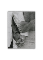 personalized wooden puzzle showing a close up of two people holding hands in black and white elegant and emotional composition