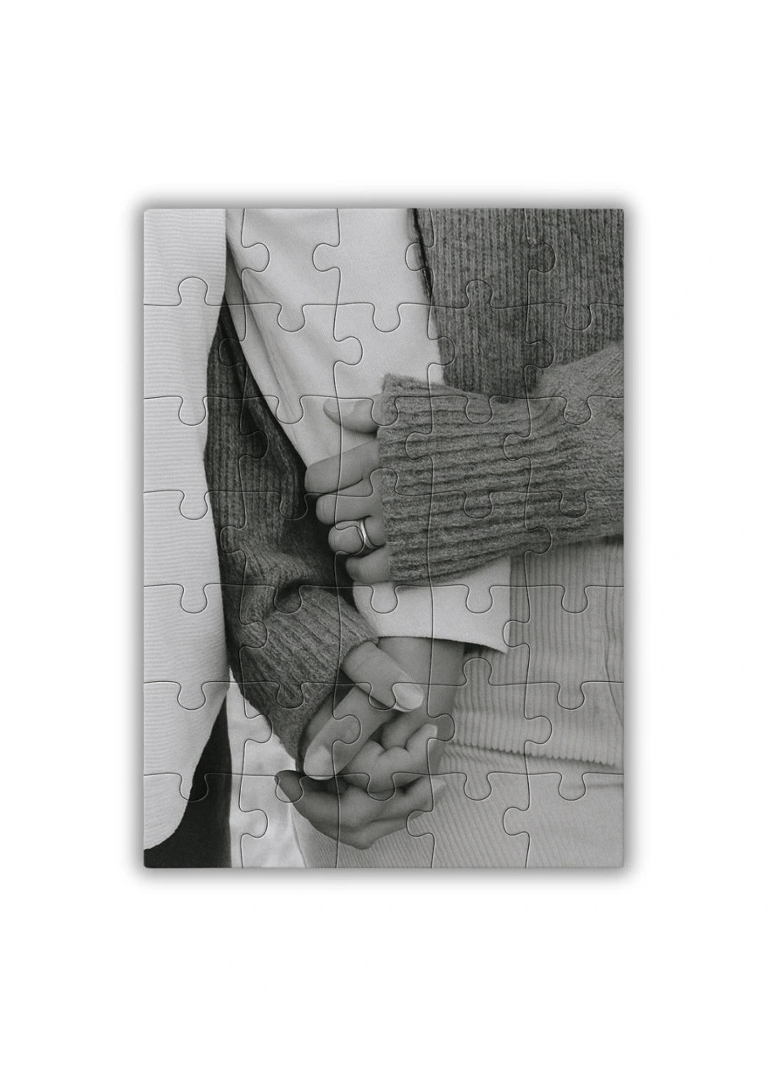 personalized wooden puzzle showing a close up of two people holding hands in black and white elegant and emotional composition