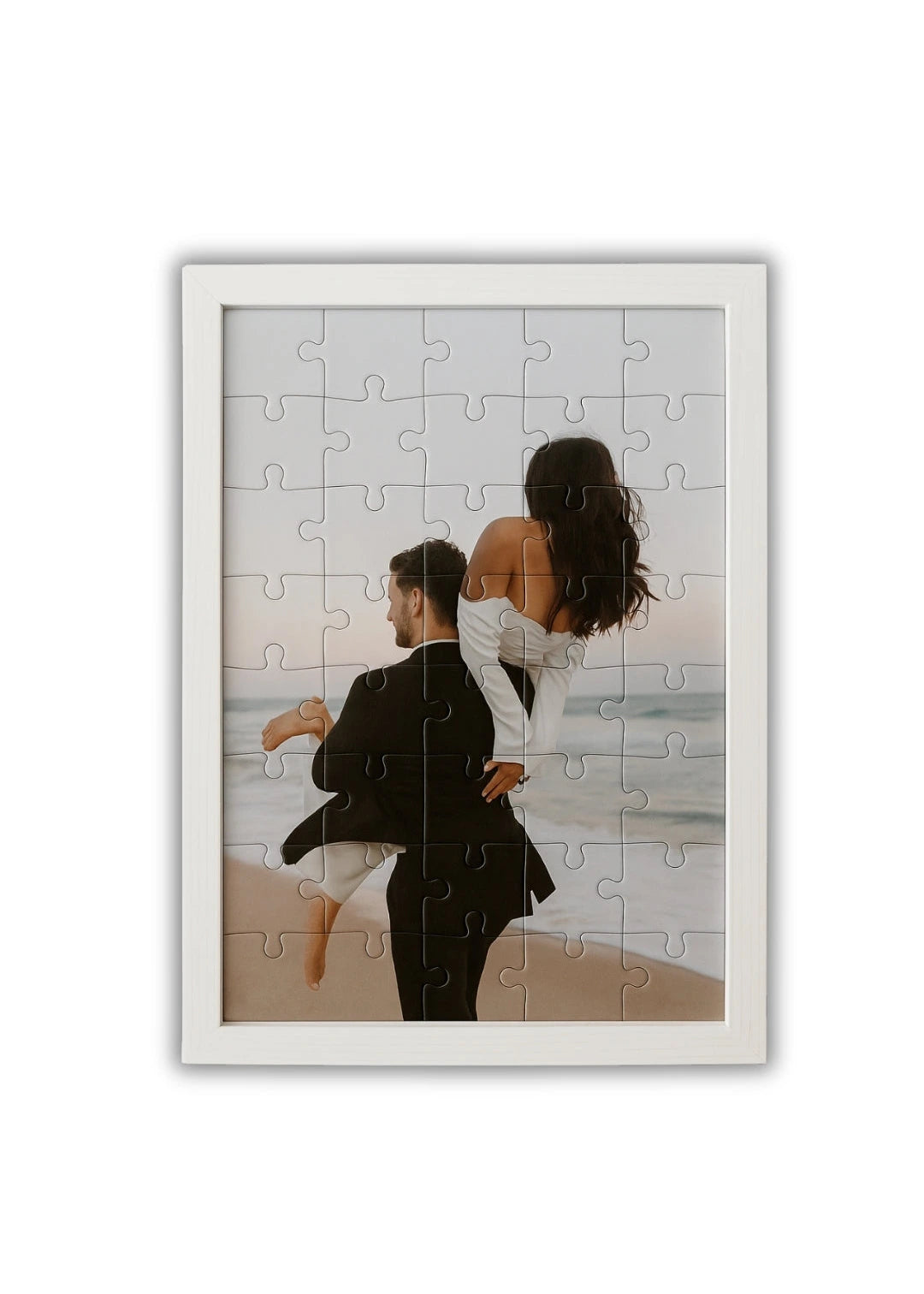 custom wooden puzzle with a photo of a couple enjoying a peaceful moment by the sea with a minimalist white frame
